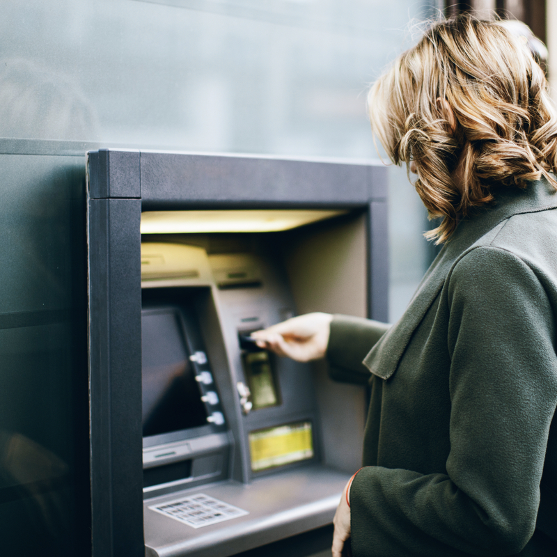 Woman using ATM