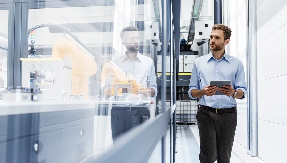 Technician controlling robots in a lab