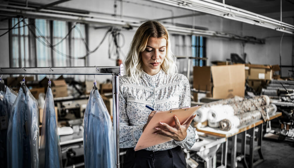 Woman in fashion industry showroom taking notes