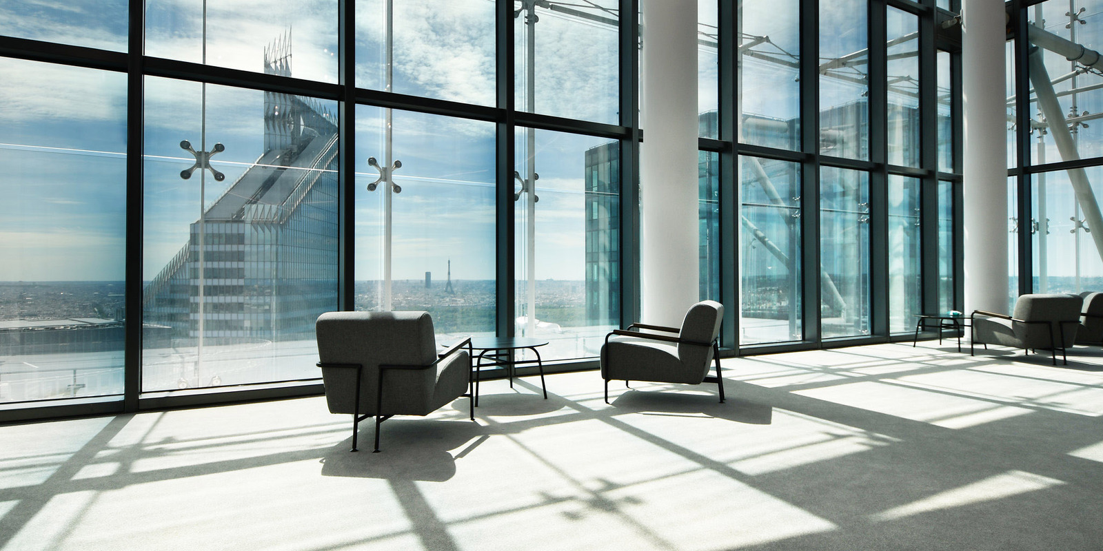 glass-walled office lounge with chairs