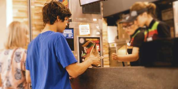 restaurant young man receives fast food   meal Adobe 