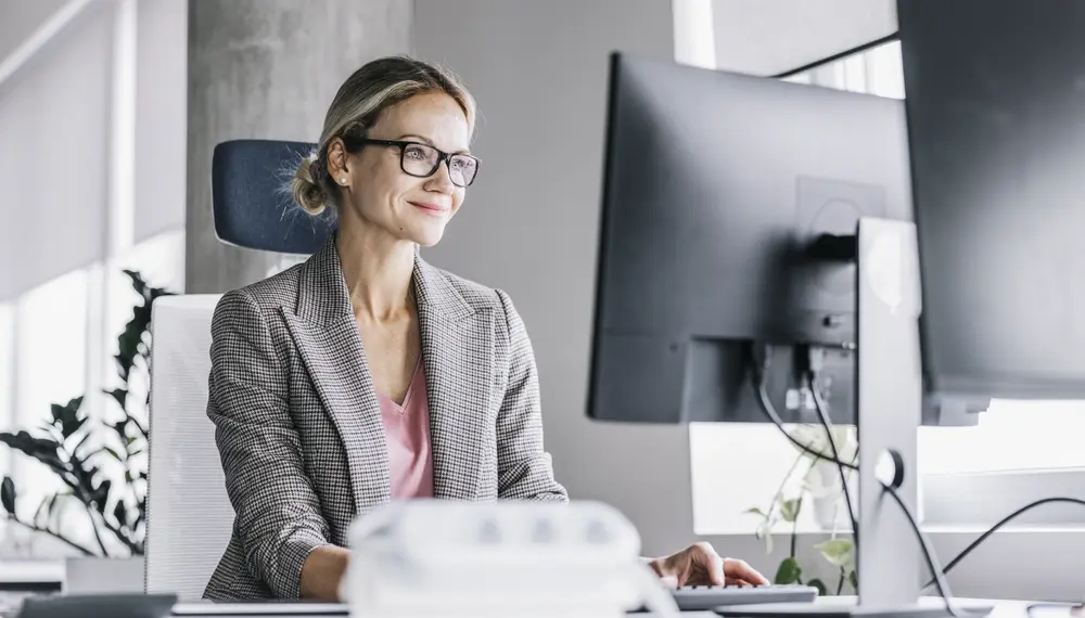 Smiling woman sitting at a computer
