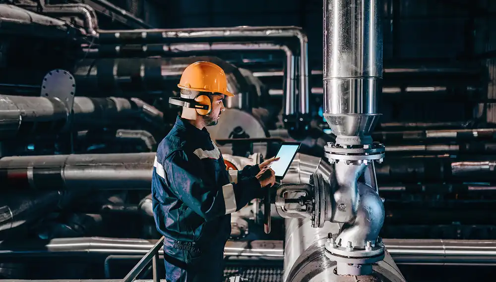 Engineer using a tablet in a manufacturing plant 