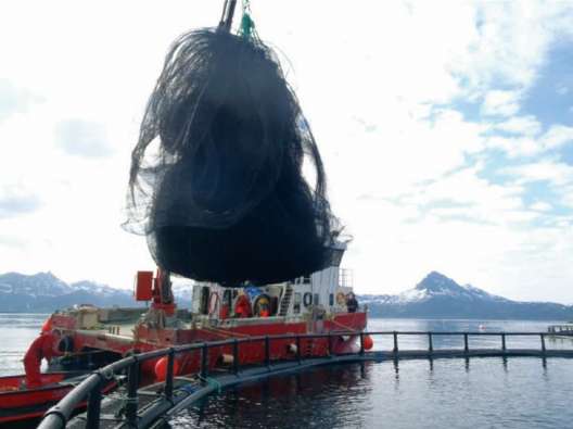 Photo of a fishing boat lifting a net