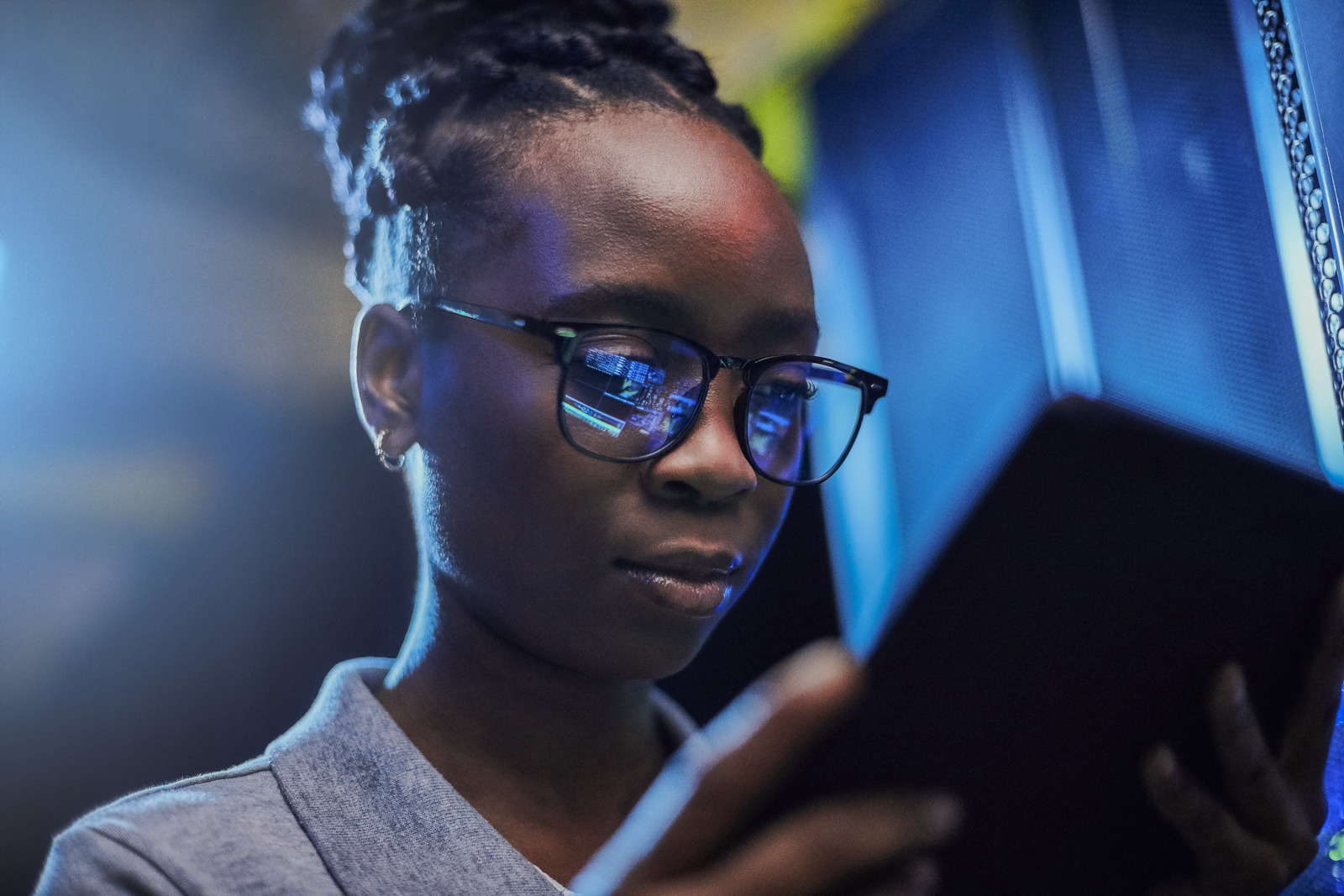 Female engineer using a digital tablet while working in a server room 