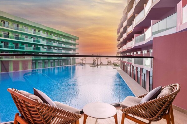 pool chairs balcony hotel sunset