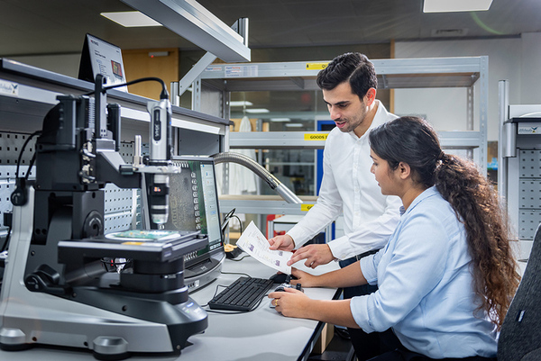 man woman technicians high-tech electronics factory