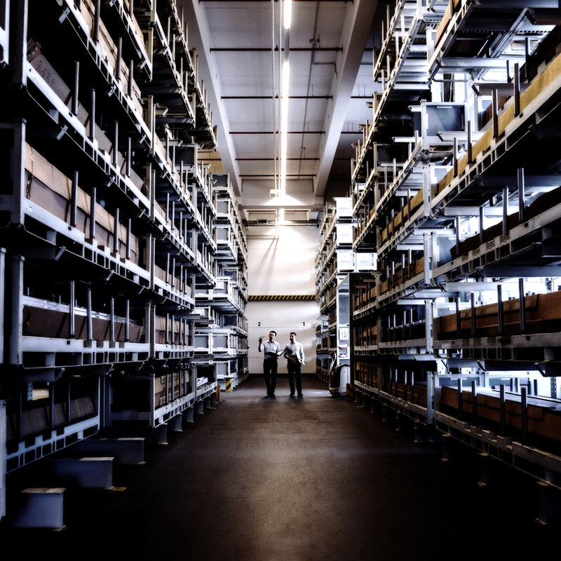 Two men walking in factory warehouse