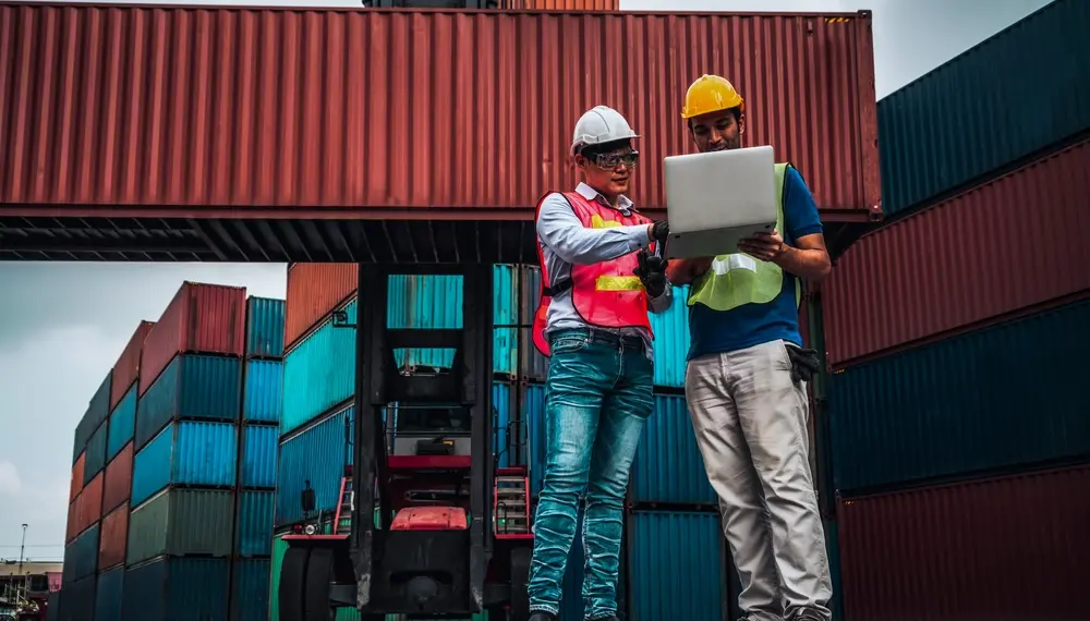 Shipping containers stacked at a busy port, representing supply chain resilience