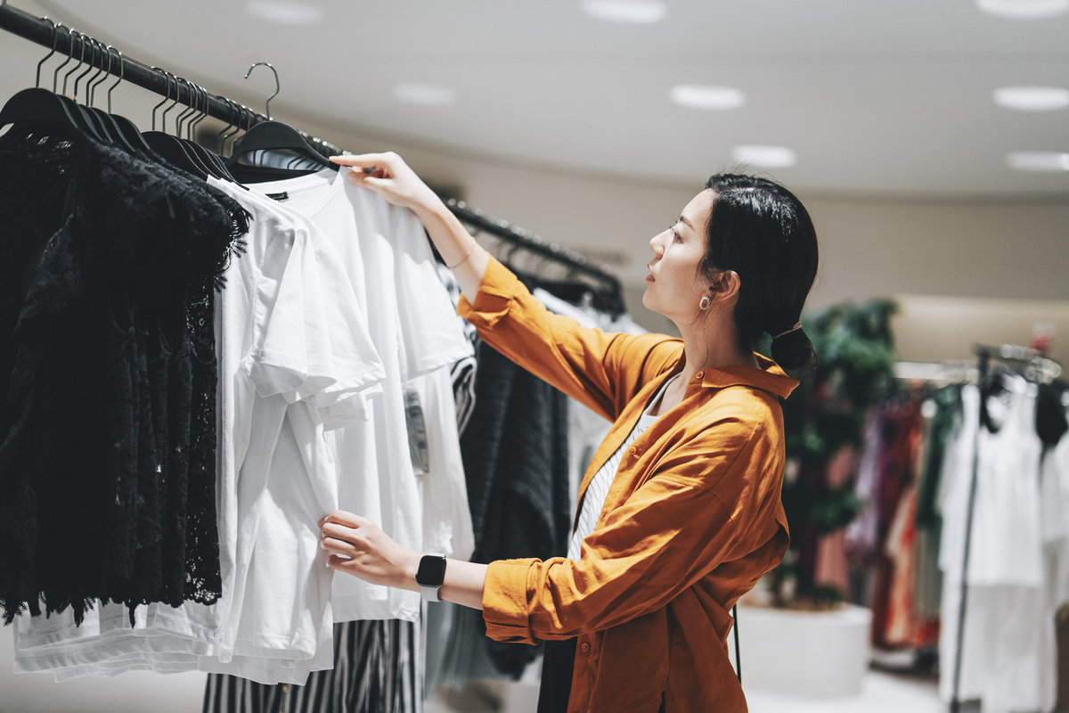 Woman looking at clothing details in store
