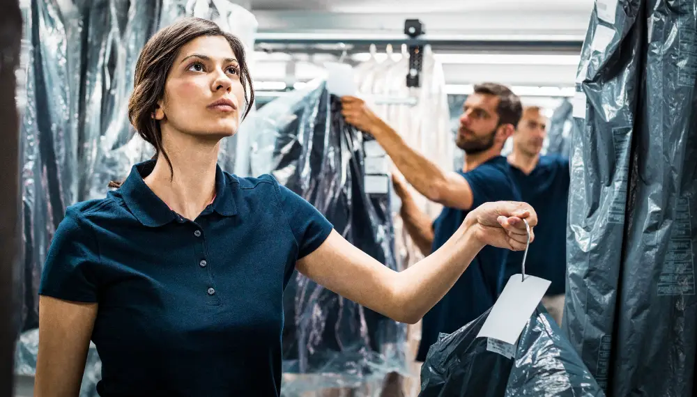 Fashion industry worker holding a garment bag