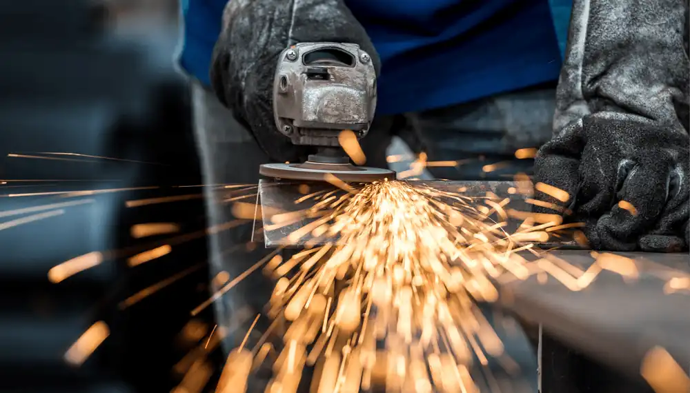 Industrial worker cutting metal