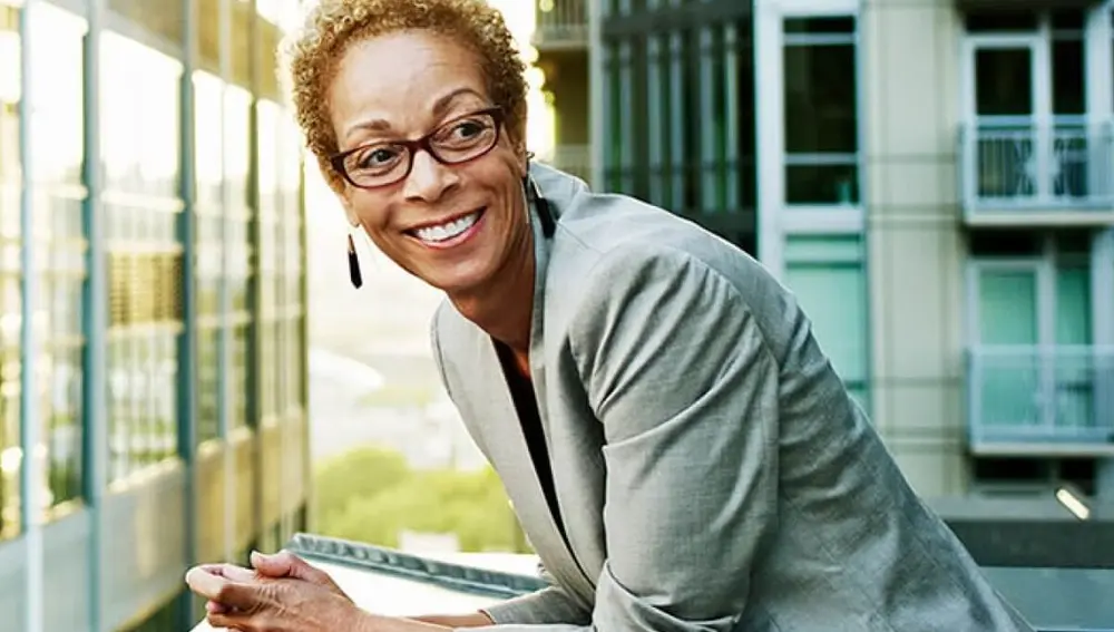 A female property manager leaning over a balcony