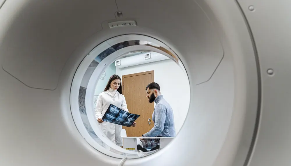 Nurse preparing a patient for an MRI scan