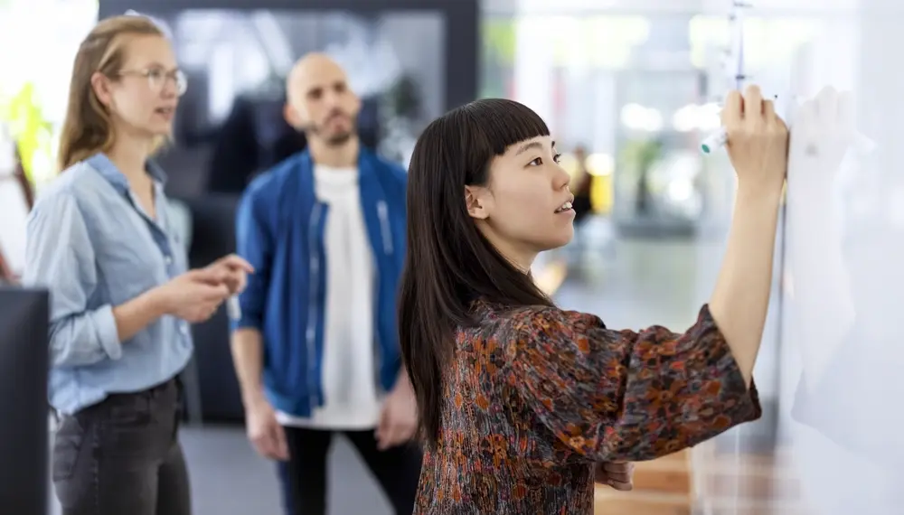 Person reviewing AI-powered ERP dashboard on a screen, illustrating AI in ERP
