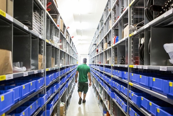 warehouse agricultural equipment farm bins shelves aisle worker