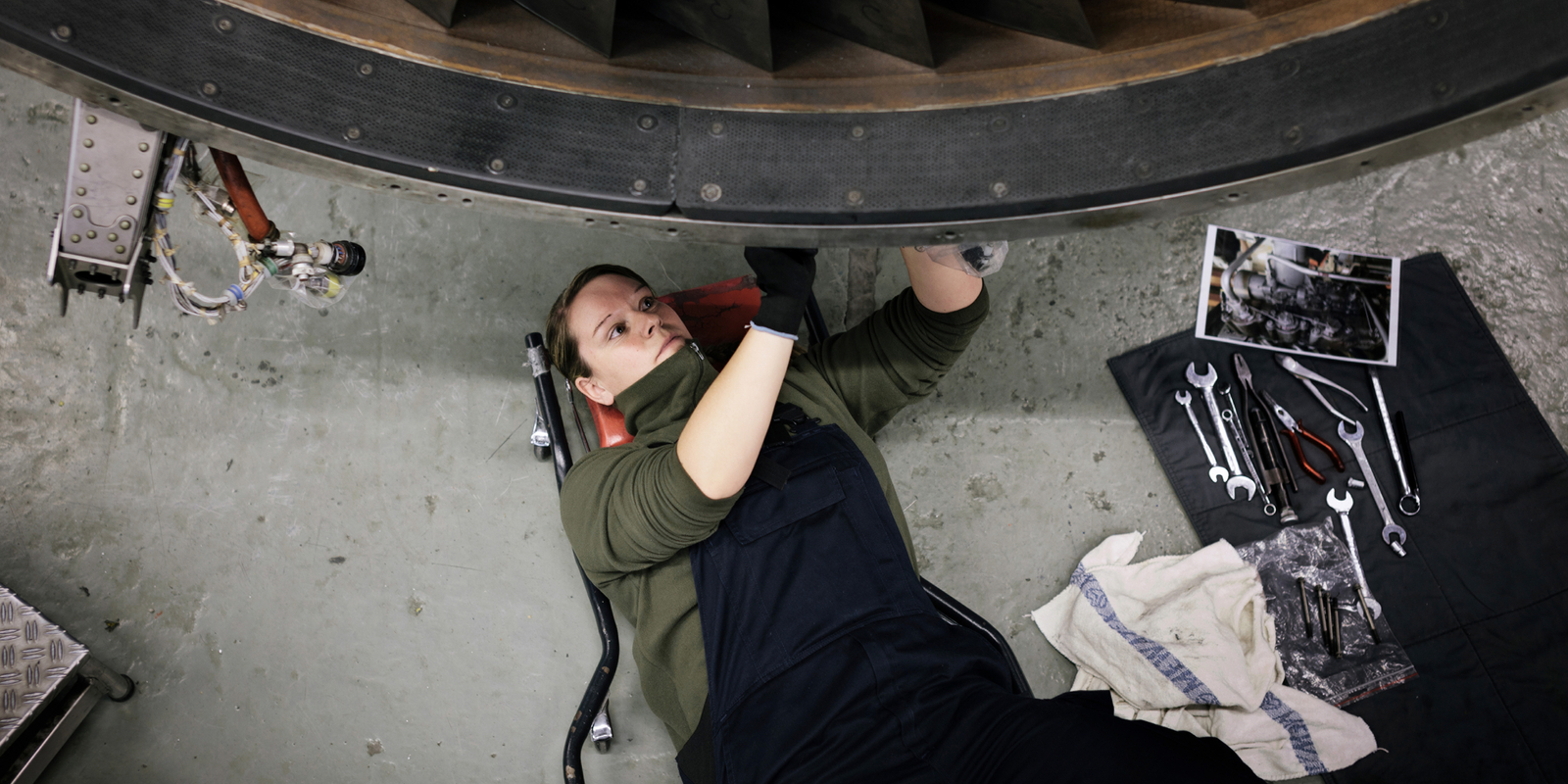 Woman Engineer fixing airplane