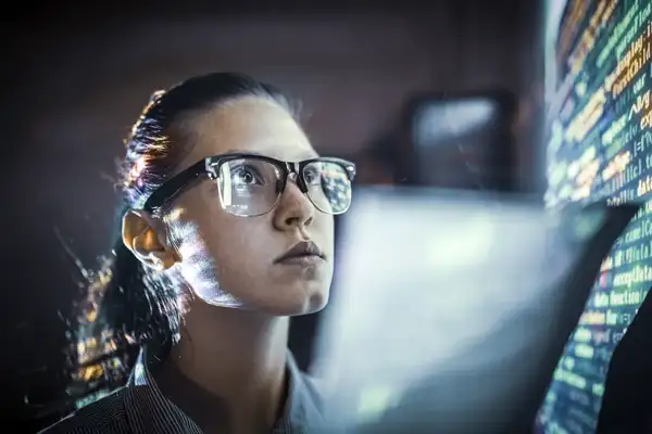 Developer with code reflected in her glasses