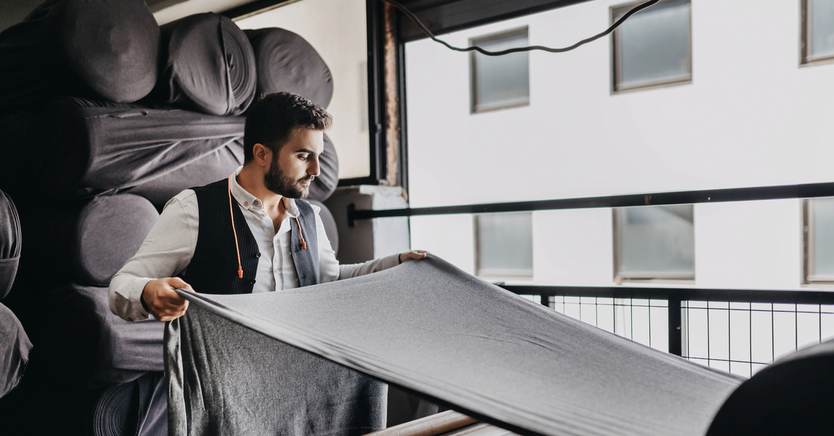 small business owner checking fabric last
  time