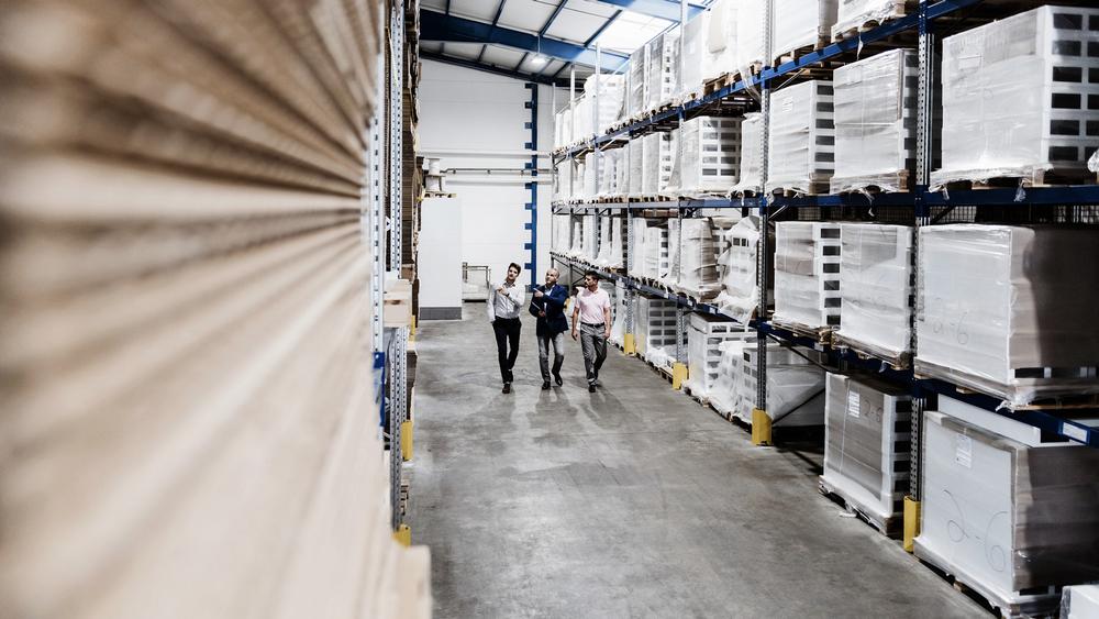 Managers walking through a warehouse 