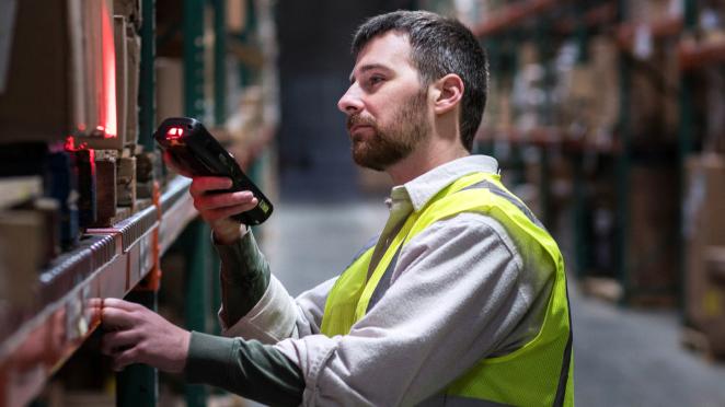 Warehouse worker representing using InforGen AI to scan product attributes