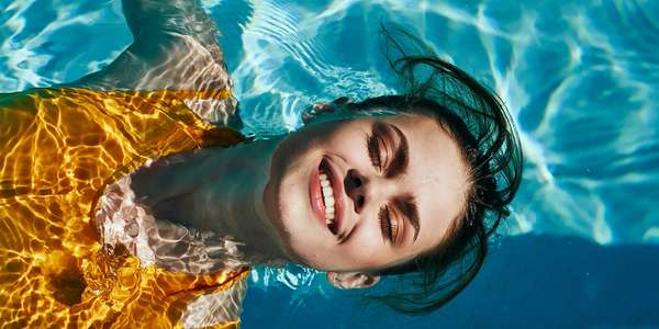 1151155827 girl yellow swimsuit swims   pool smiling