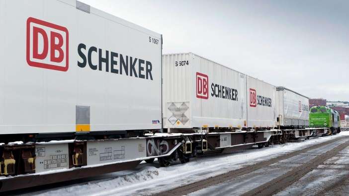 db schenker containers on train cars in the snow