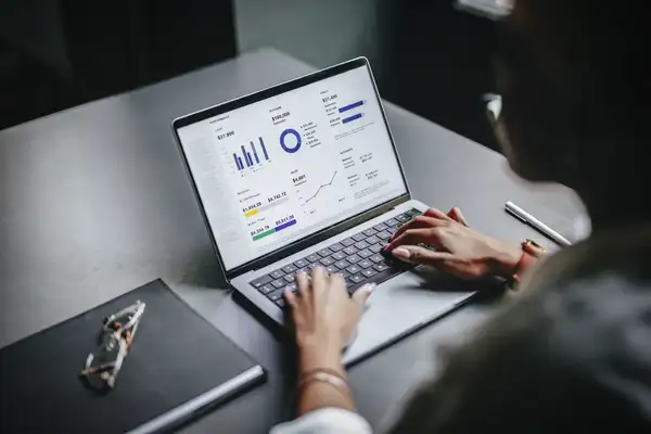 Manager using professional services software on a laptop