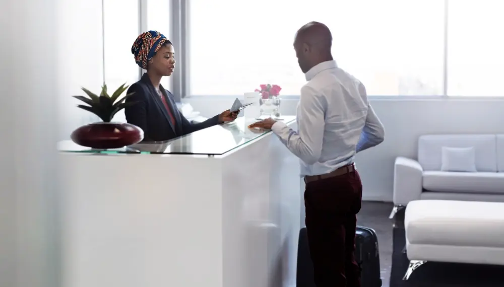 Guests checking in at a hotel lobby, highlighting Infor's hospitality solutions