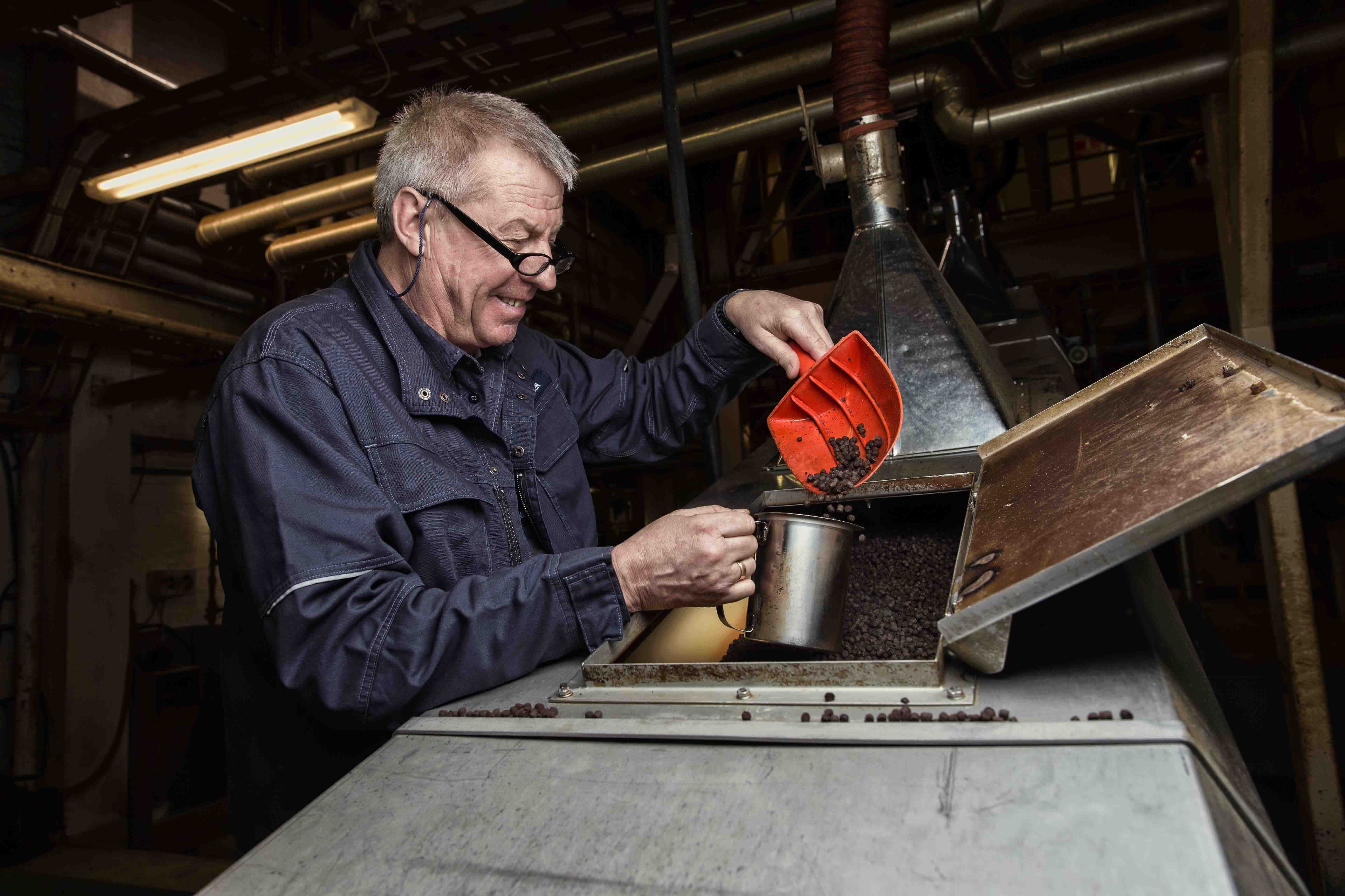 coffee roaster scooping up grounds