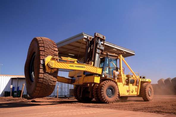 Forklift equipment machine lifting a tire