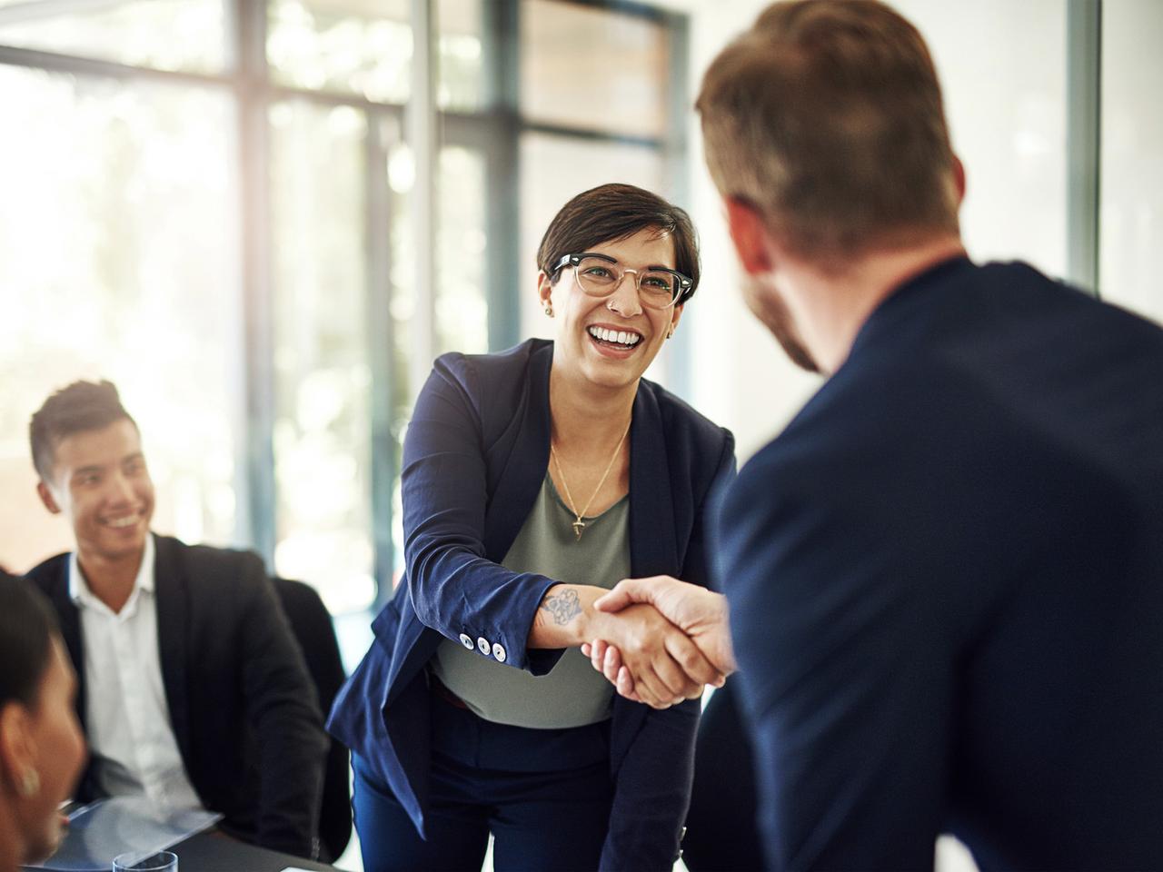Infor partner shaking hands with a customer