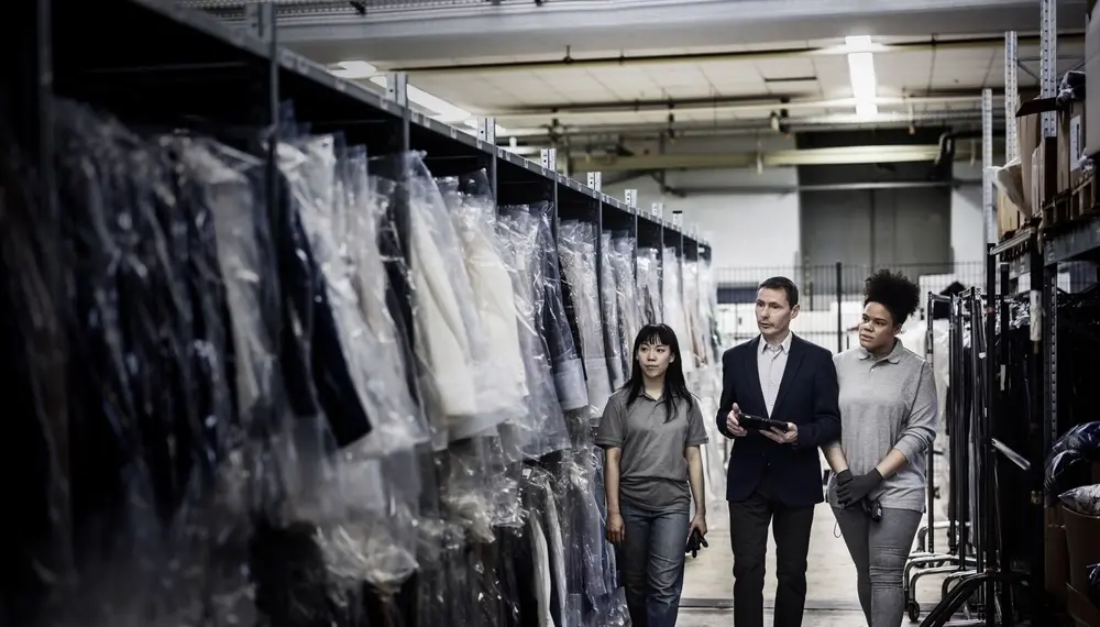 Store manager and workers checking fashionwear stock inventory