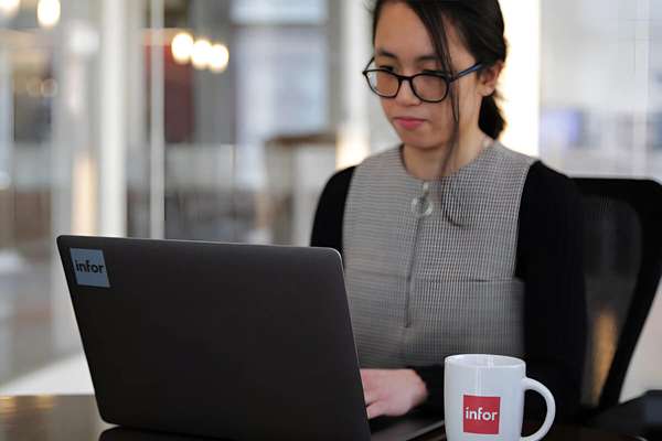 Infor HR manager publishing a new job posting on her laptop 