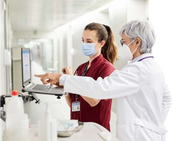 Two masked healthcare managers control ROI with an optimized supply chain.