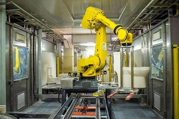 robotic manufacturing arm operating in a factory