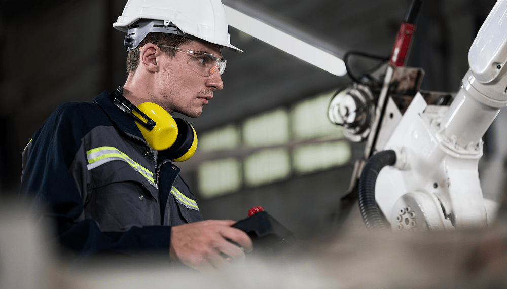 Engineer controlling a robotic arm