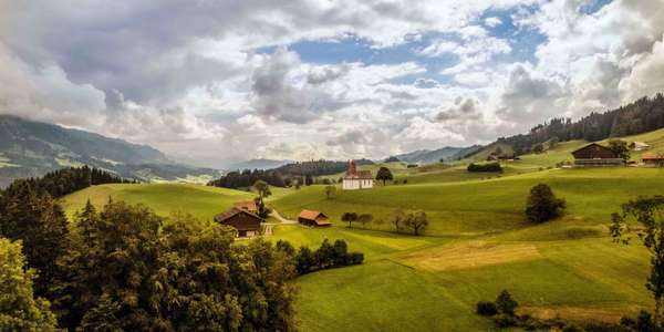 Swiss mountain meadows houses church