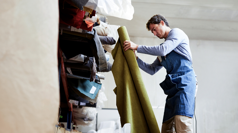 Worker Examining Fabric Workshop