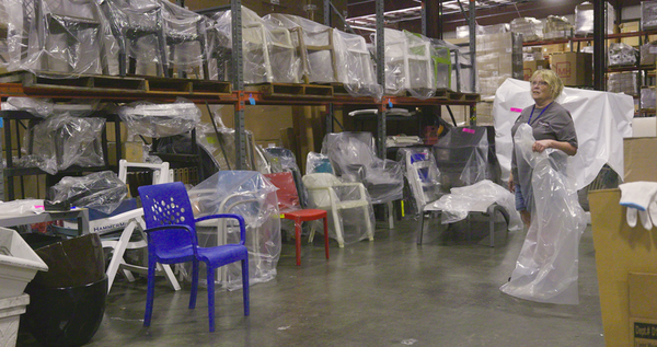 furniture in warehouse with woman worker