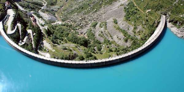 dam reservoir mountainside switchback road