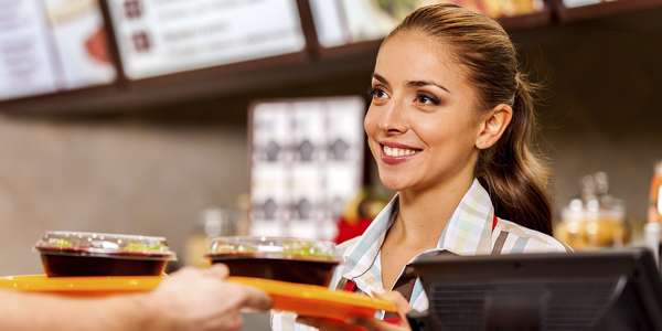 restaurant worker serves fast food meal