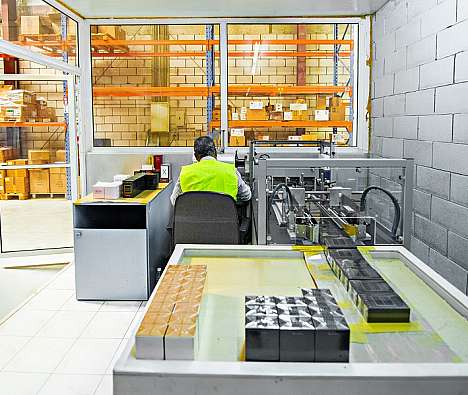 photo of a warehouse worker in orange vest