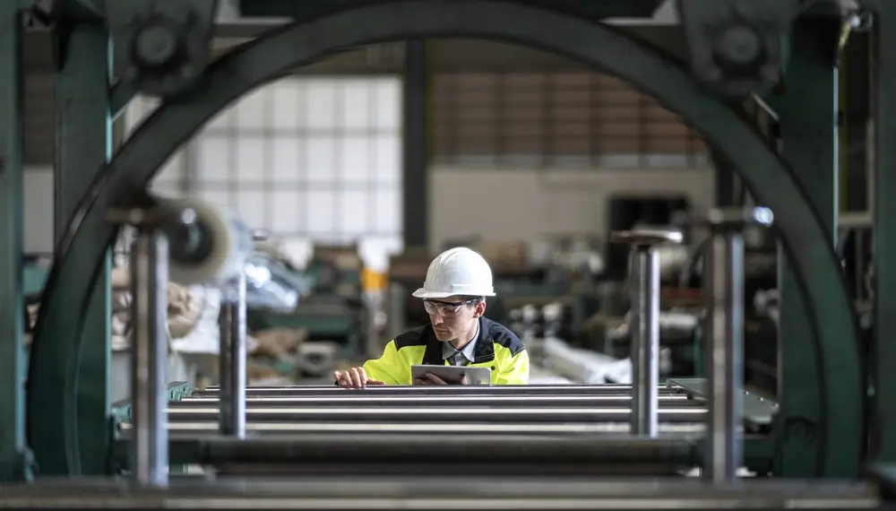 Engineer using ERP on a tablet in a factory 