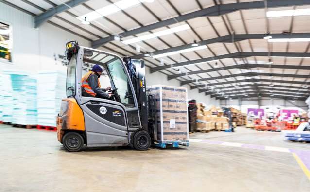 Man on forklift in warehouse