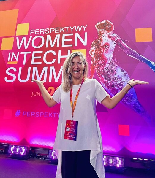 Hanna Witek woman smiles celebrates in front of banner