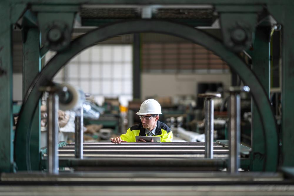 Factory worker using manufacturing software on a tablet 