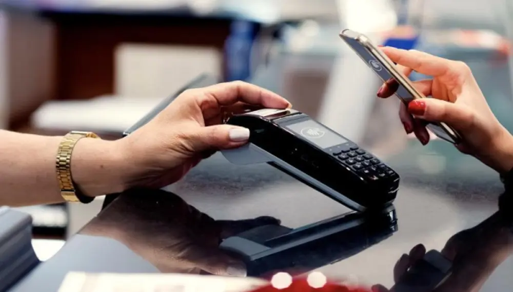 Tap to pay purchasing with a customer’s mobile phone with a merchant